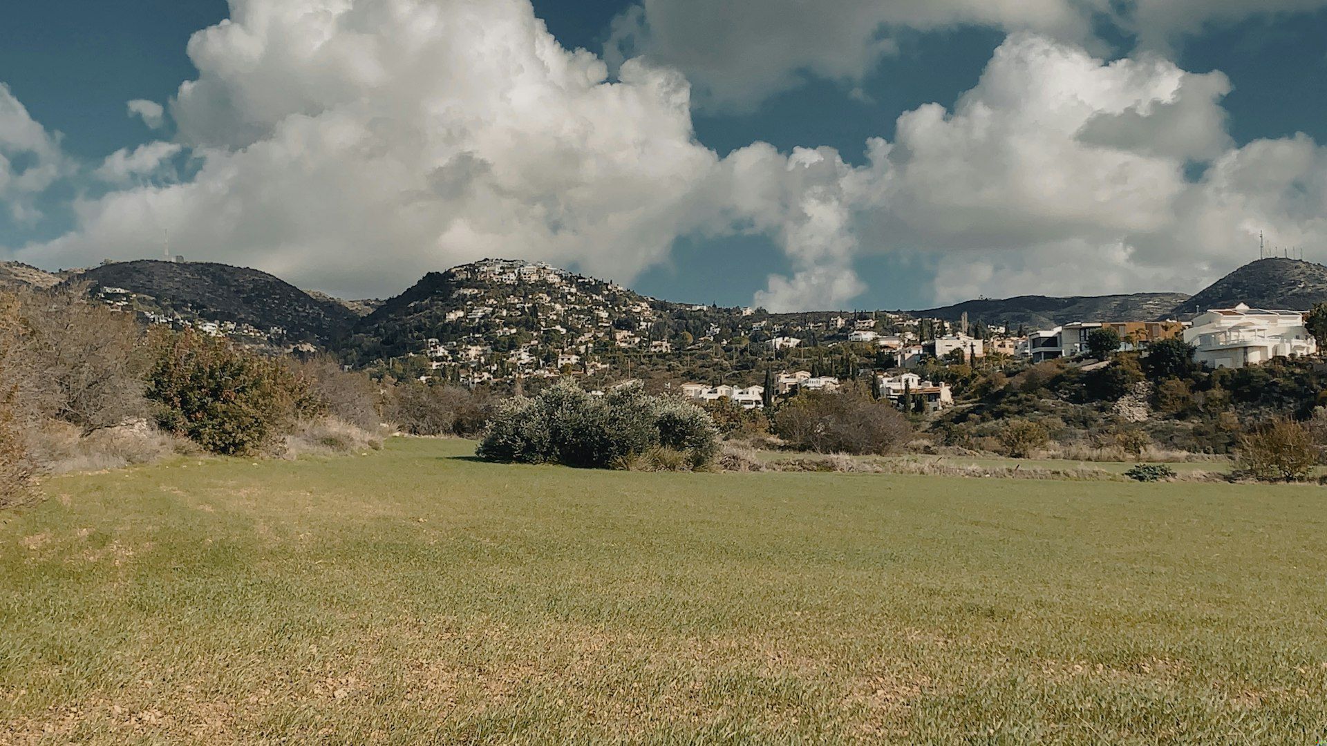 A scenic village lies beneath a cloudy sky.